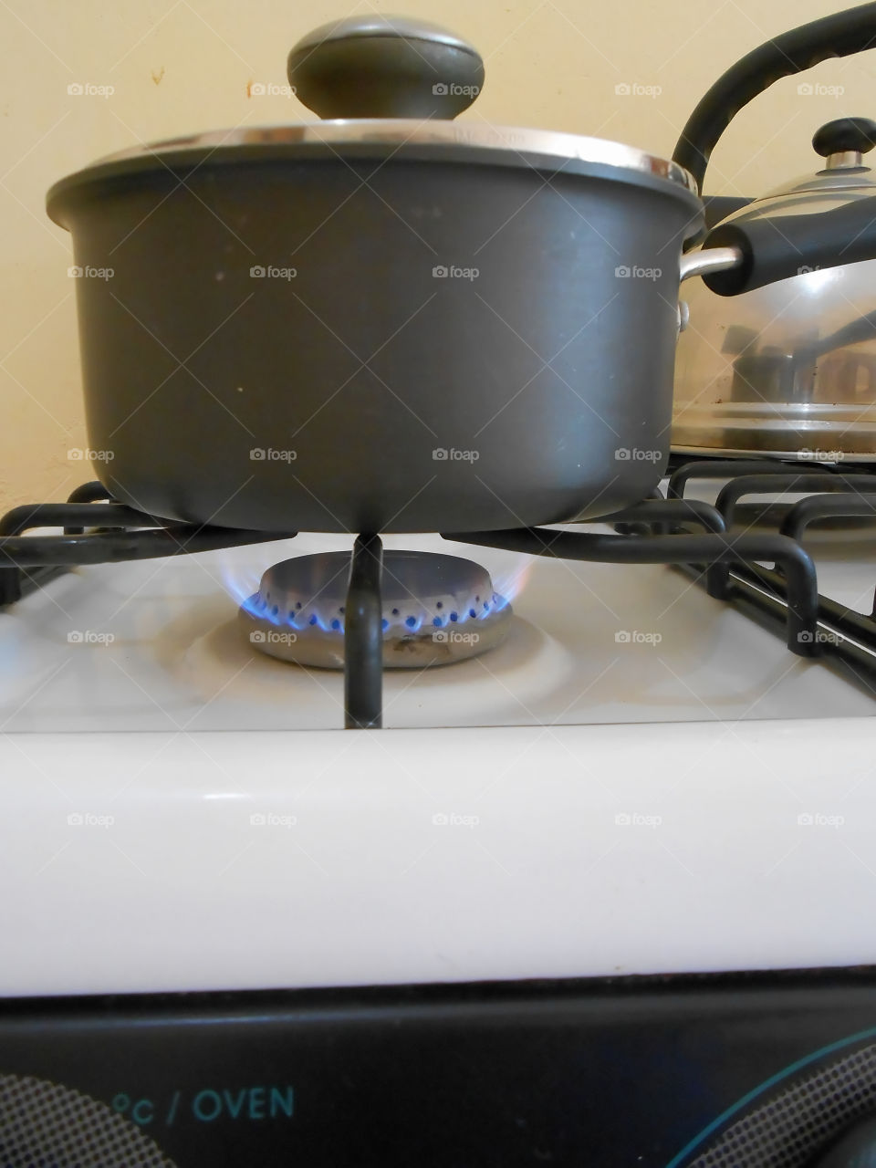 Pot On Stove Over Lit Burner