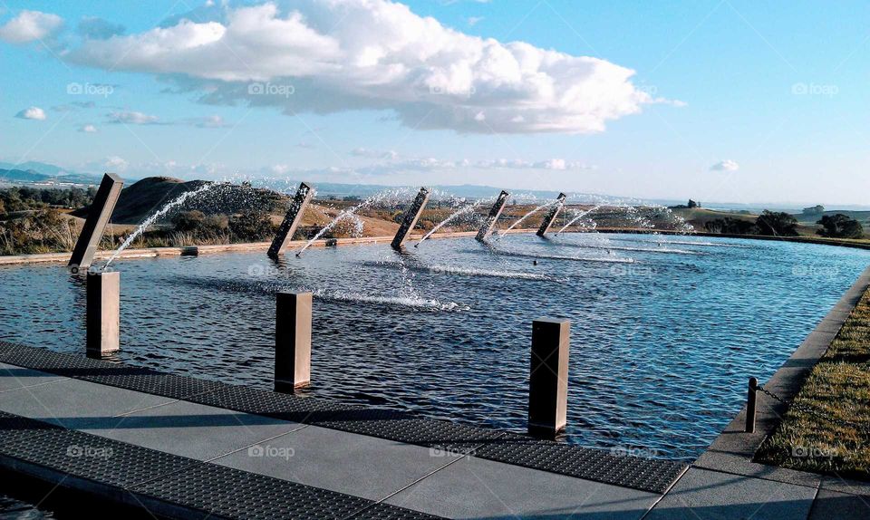 Fountain in a row at pond in the park