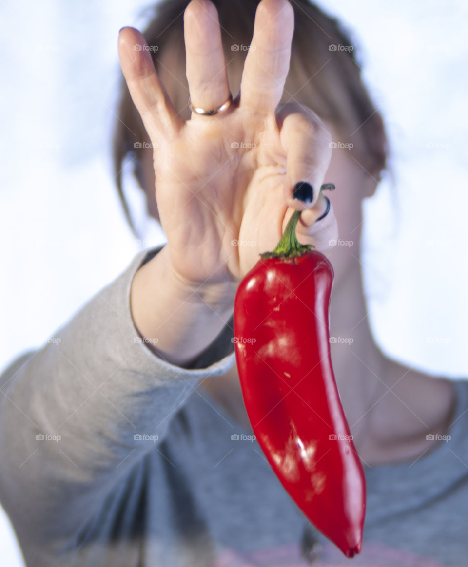 The girl is holding vegetables