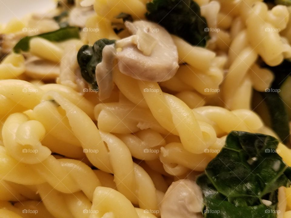 Close-up of mushroom and kale pasta