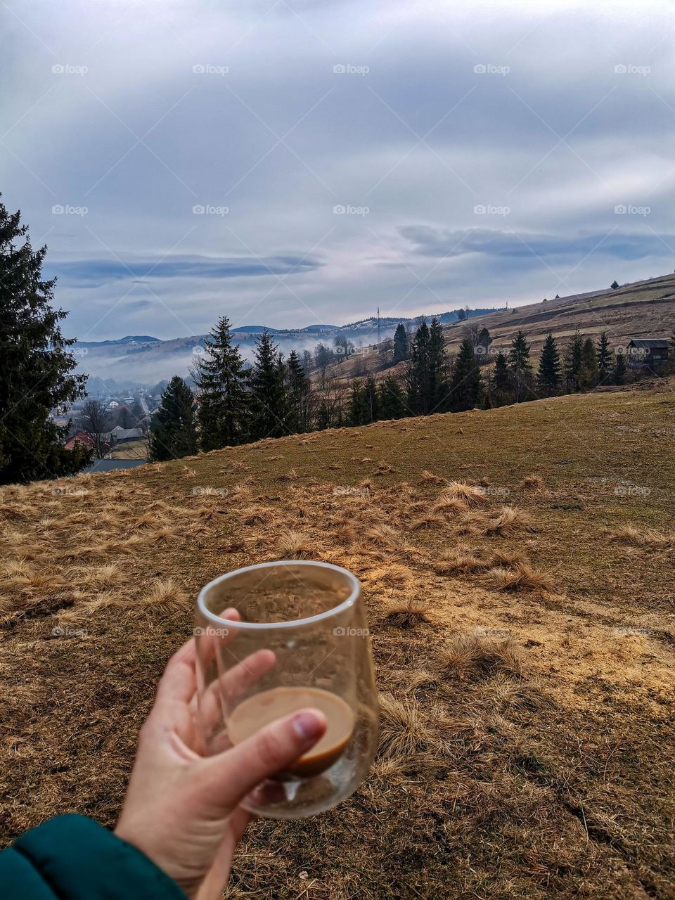 Incredibly beautiful and picturesque early spring mountain landscape with fog, hills and trees