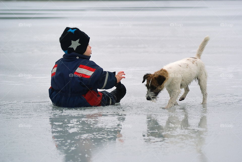 Child and a dog on the ice