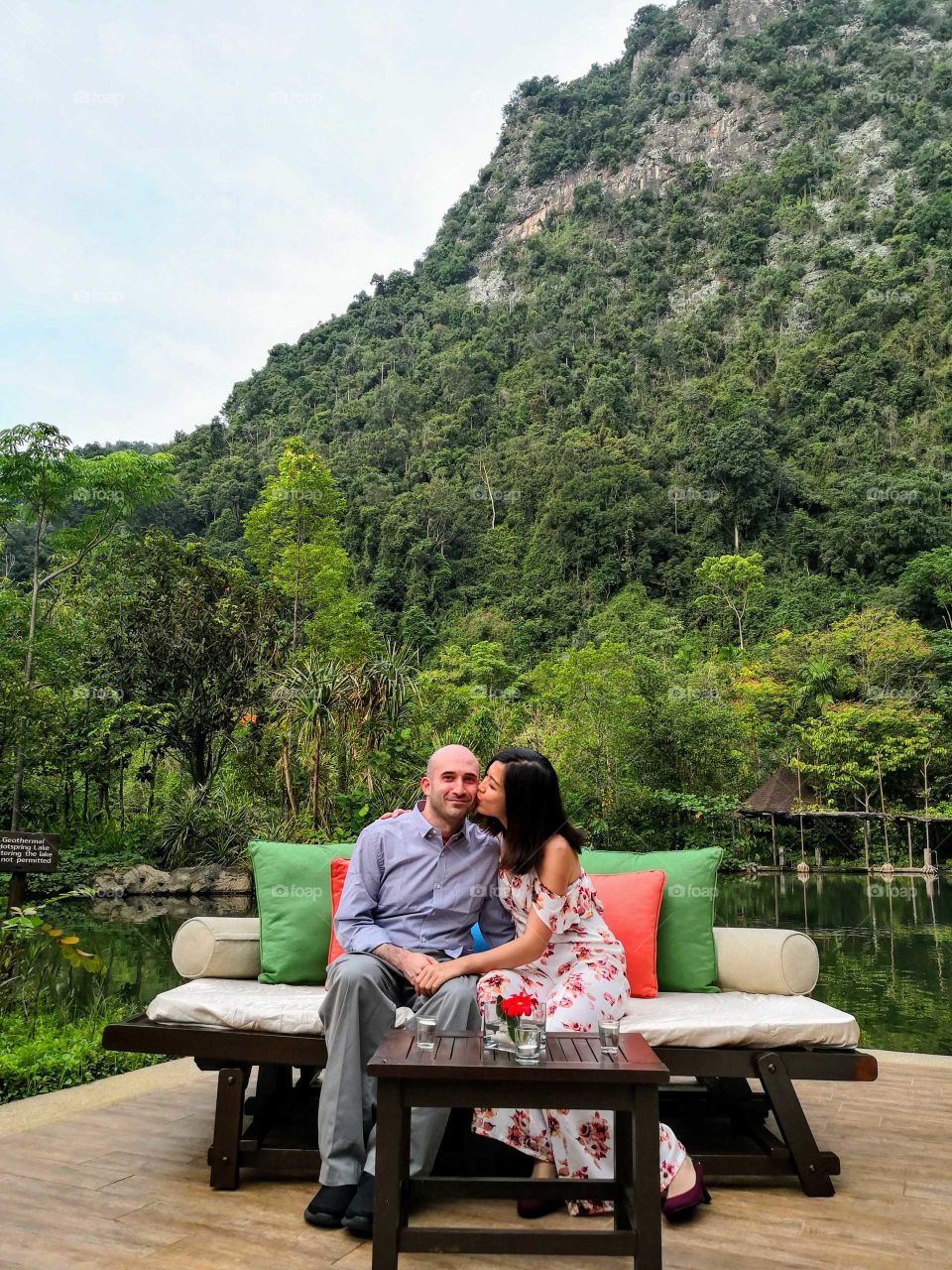 Malaysia. Kissing in front of a mighty mountain and lake.
