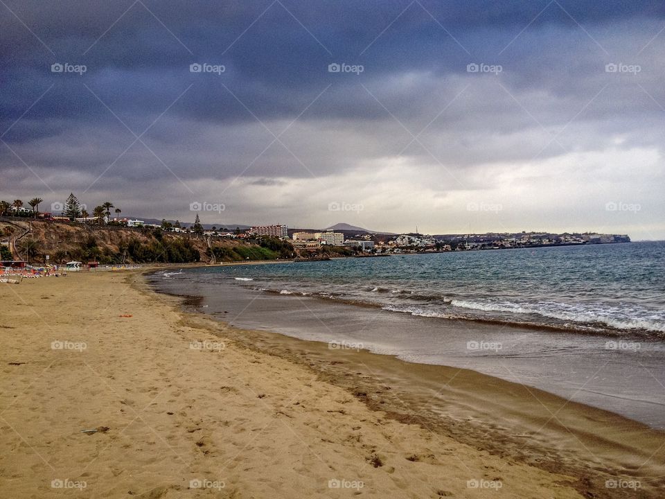 Storm cloud over idyllic sea