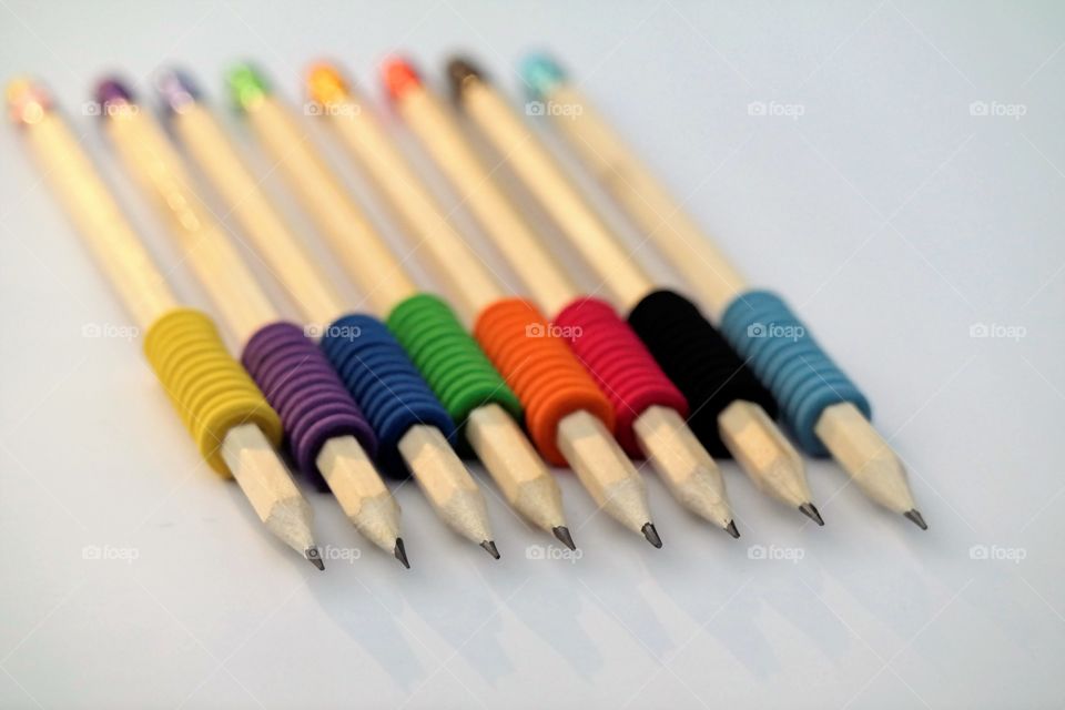 Pencils colorful eraser on white paper sheet 
