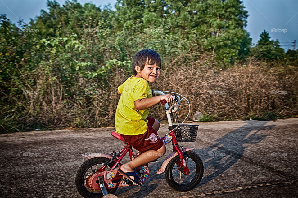 Young boy riding bicycle. afternoon fun outdoor activity