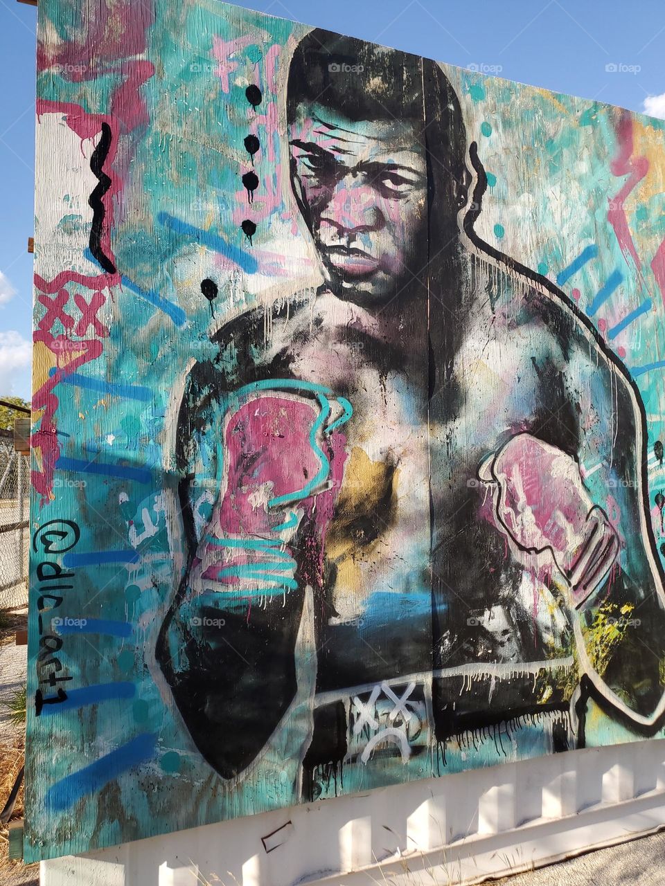 A urban outdoor art mural of what appears to be "The Greatest," also known as the great professional boxer Muhammad Ali. Born in Louisville, Kentucky, USA.