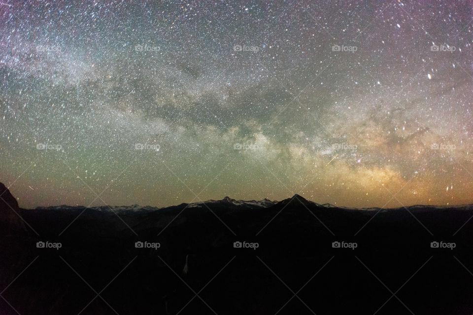 Silhouette of mountains above milky way