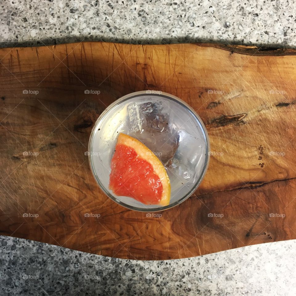 Cotswold dry gin and tonic on an olive wood board