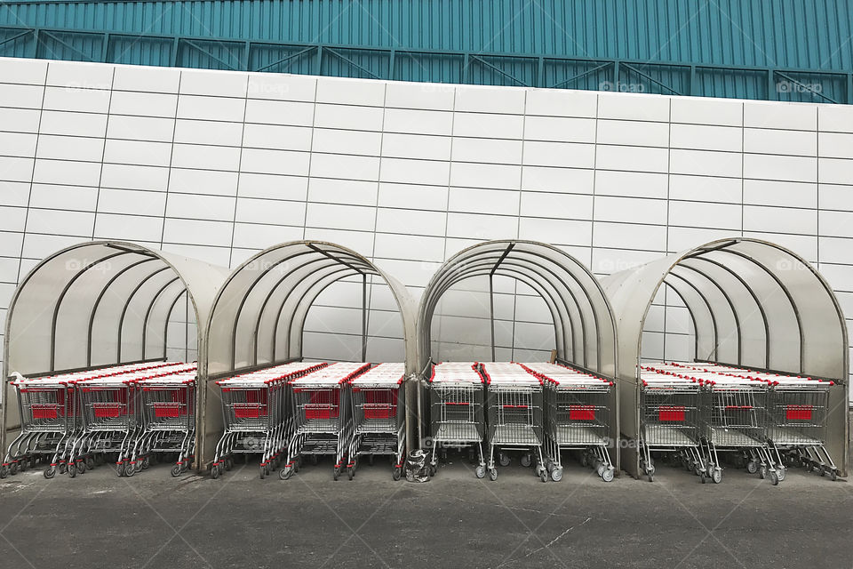 Metal shopping carts at the geometric mall wall 