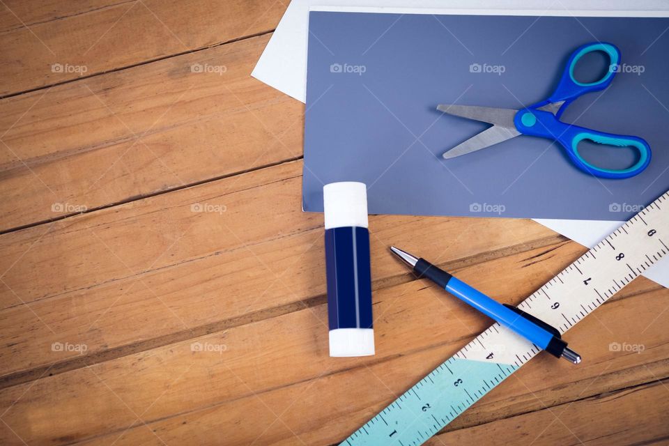 image of Directly above shot of scissor on papers with school supplie