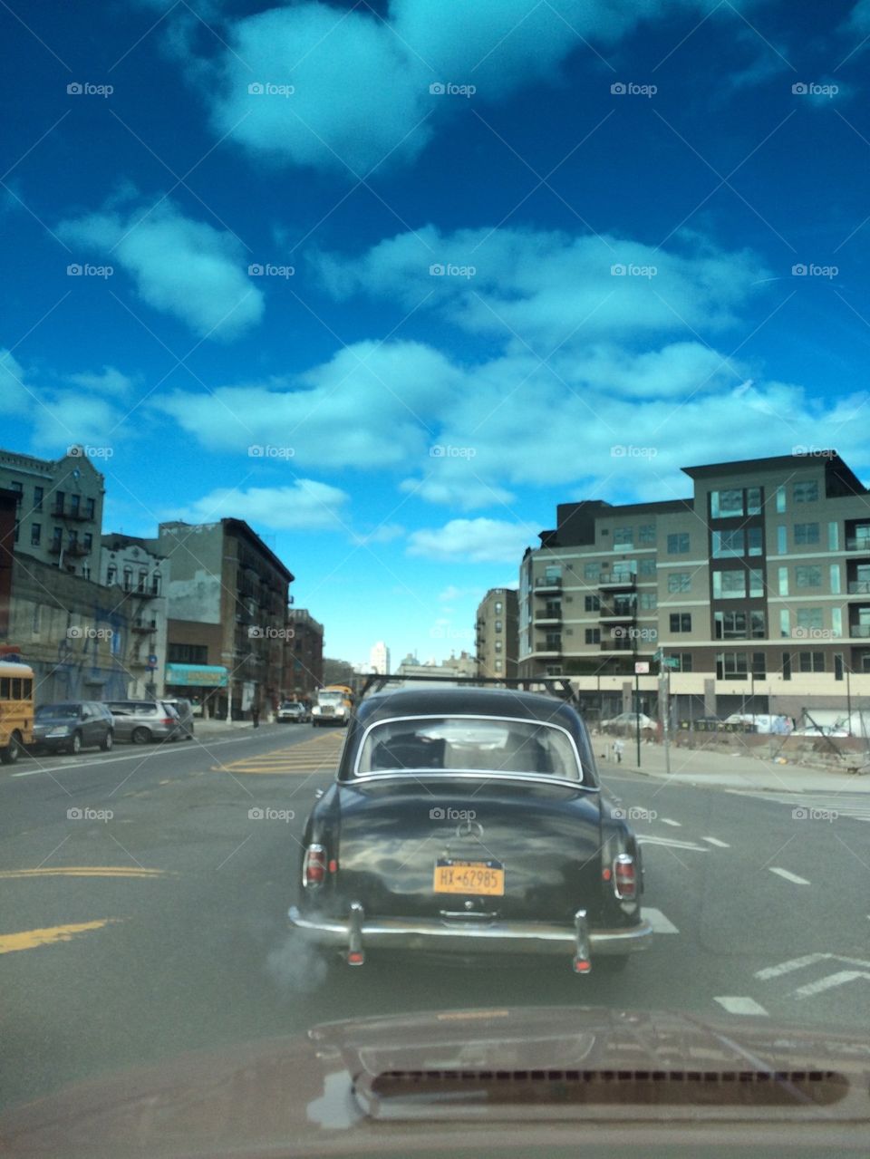 Old Mercedes driving down a Brooklyn street
