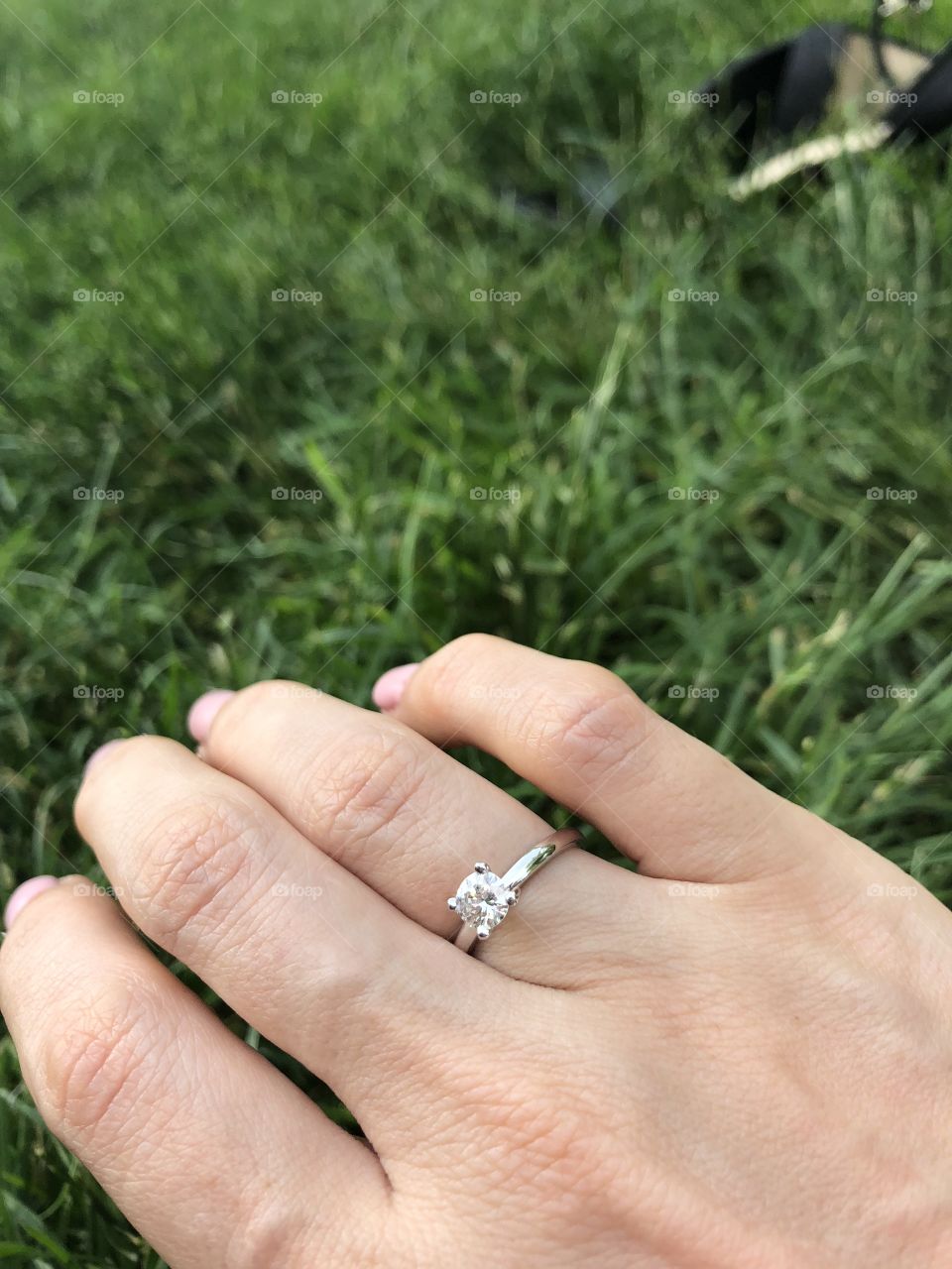 Proposal ring with diamond on a hand of young woman 