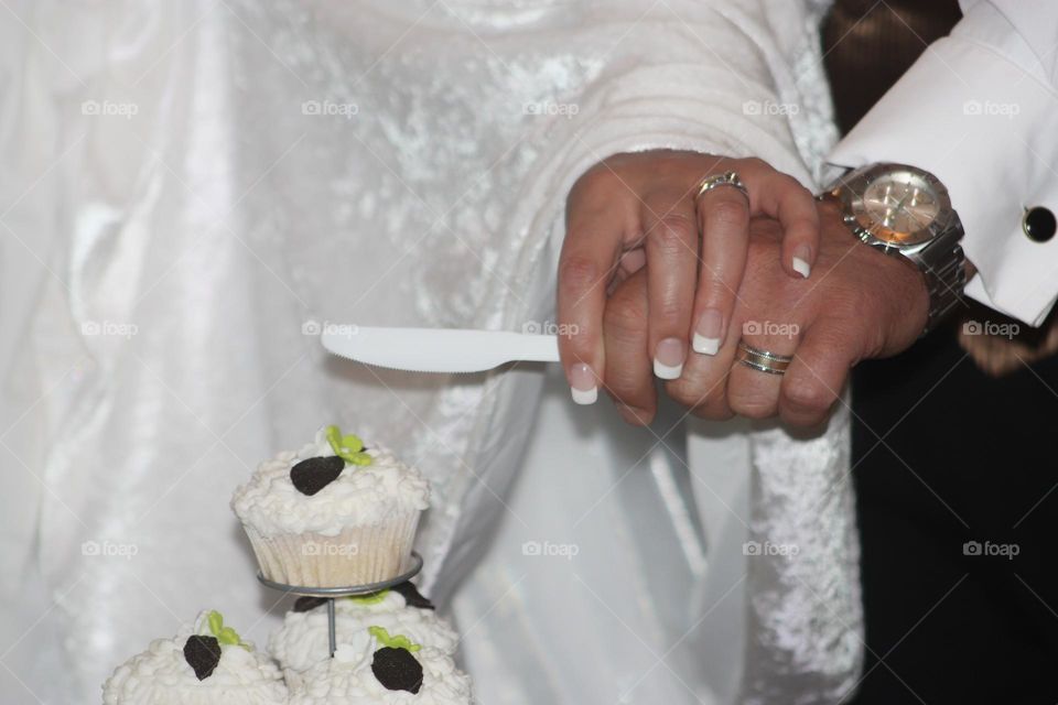 cutting cake in a white dress