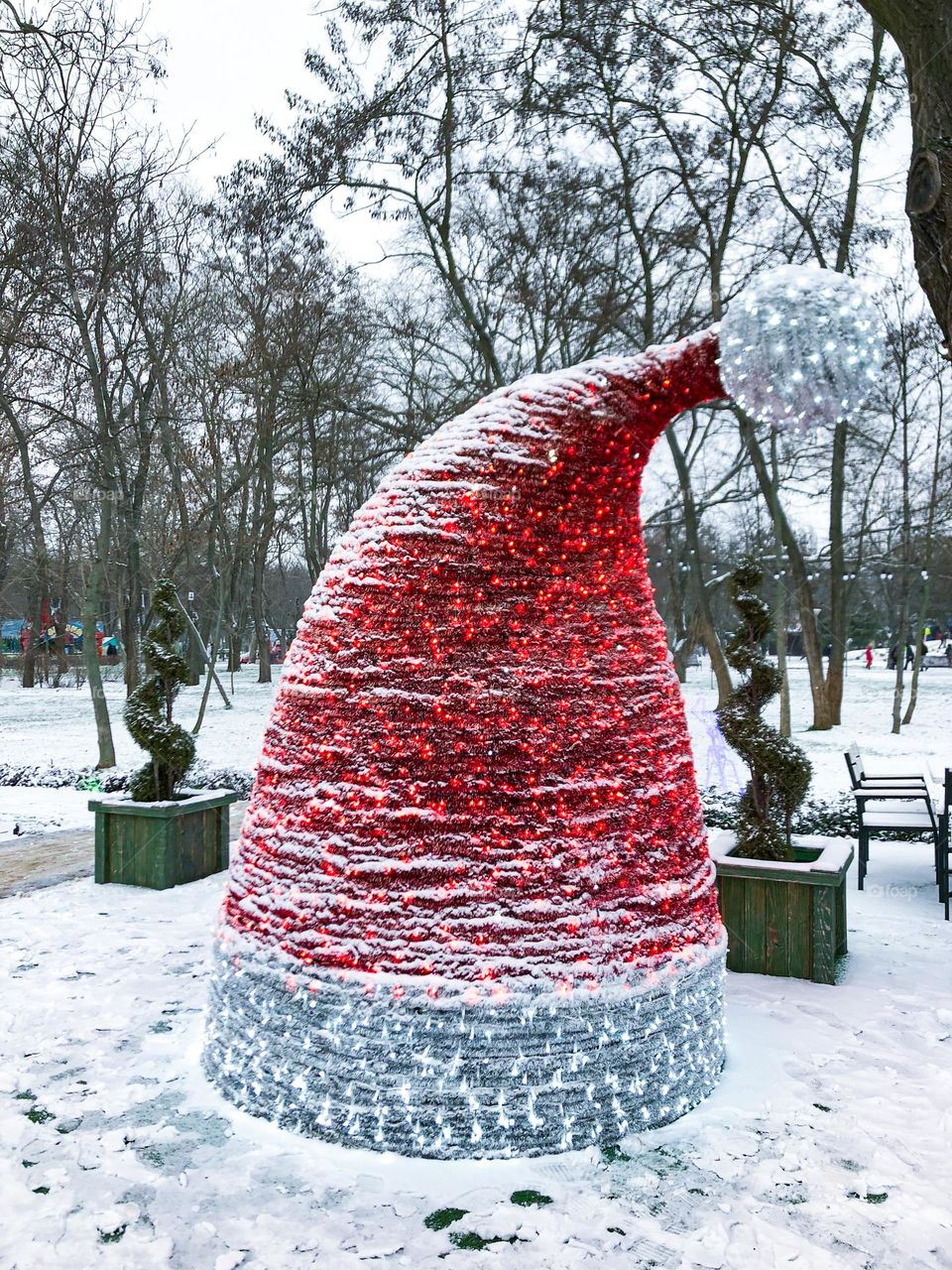Red Santa Claus’s hat as installation in a snowy park