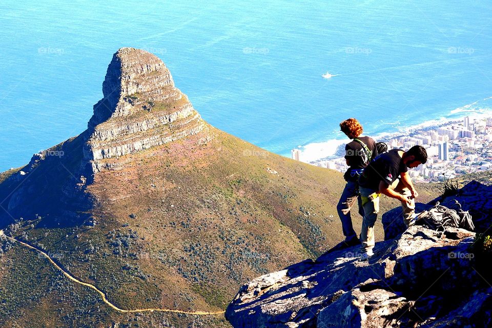 2 guys scaling Table mountain in Cape Town South Africa