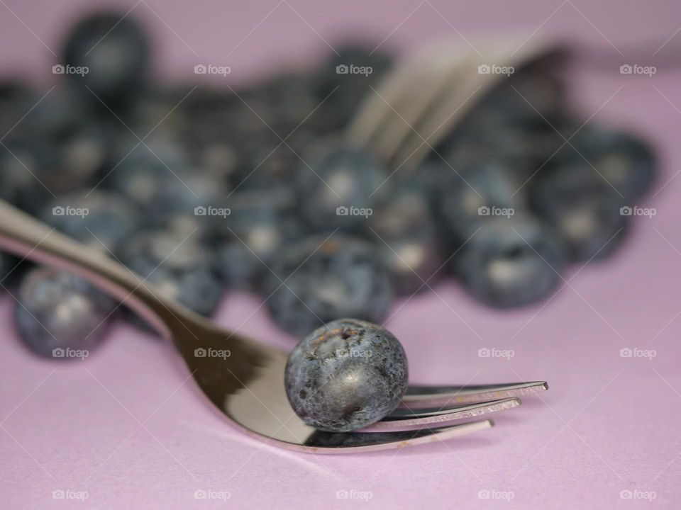 One blueberry on fork