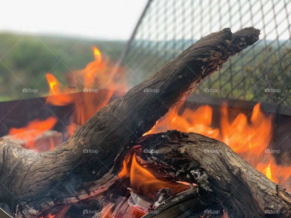 In preparation for a true barbecue session in South Africa. Wood on fire in a metallic grill. Fire destroyed the wood yet the metal survived