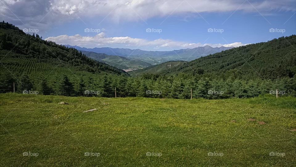 Green mountain blue sky