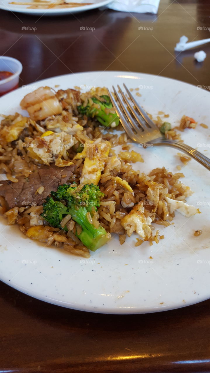 Asian hibachi grill. Rice, chicken, eggs, broccoli, pork, mushrooms and shrimp.