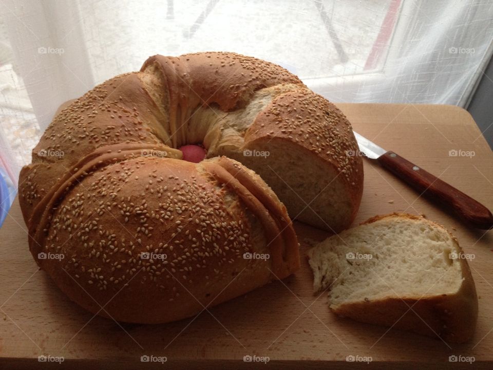 Fresh loaf of bread prepared for Easter with a red egg in the centre 