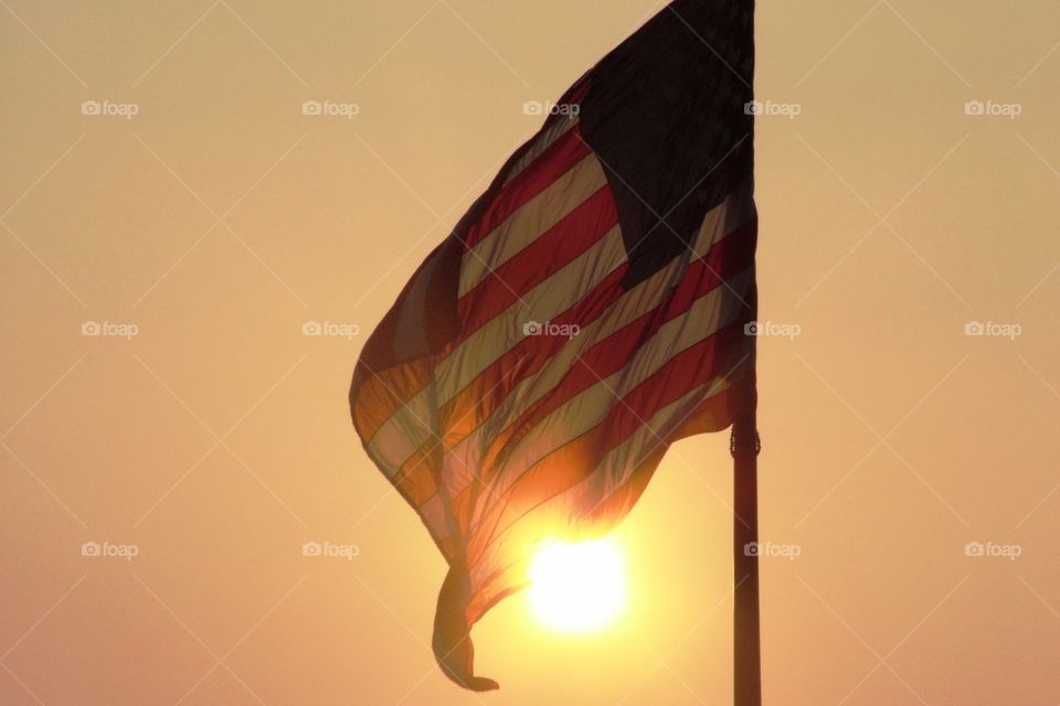 American Flag waving in the sunset