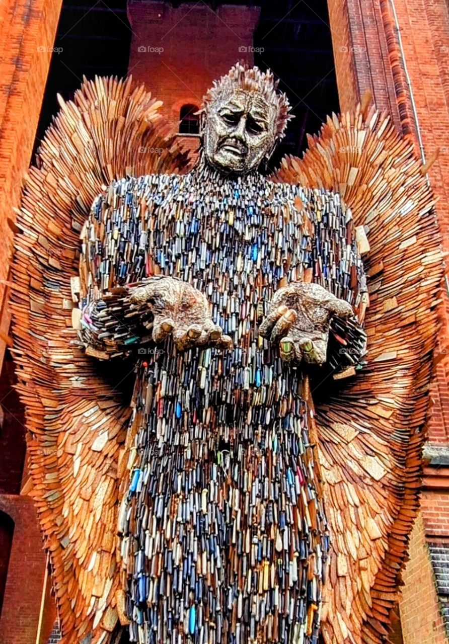 Knife Angel - Sculpture of an angel made out of multi coloured knifes with bronze face and hands