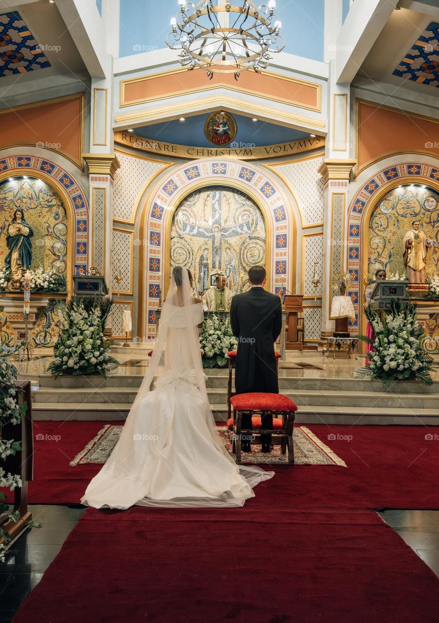 Cute couple getting married in a beautiful Catholic Church