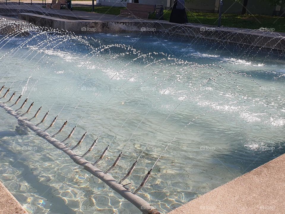 Refreshing view of the fountains in a small city on a hot spring day.