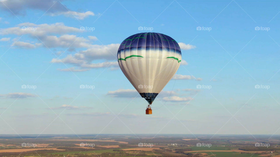 Hot air balloon flying with blue sky background. 