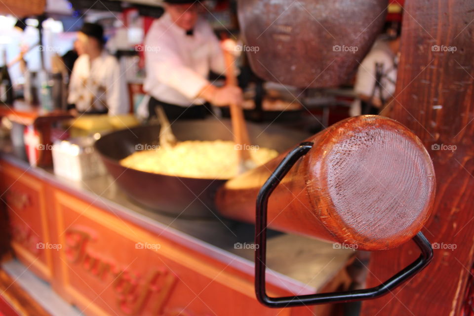 Handle of the pot in the foreground in the kitchen