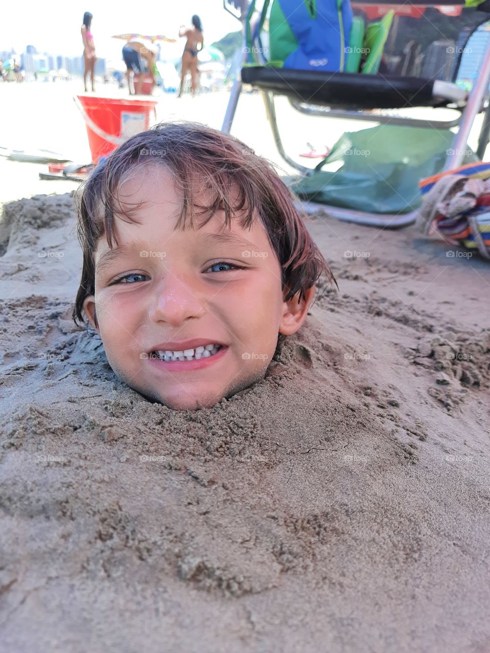 child playing in the sand on the beach