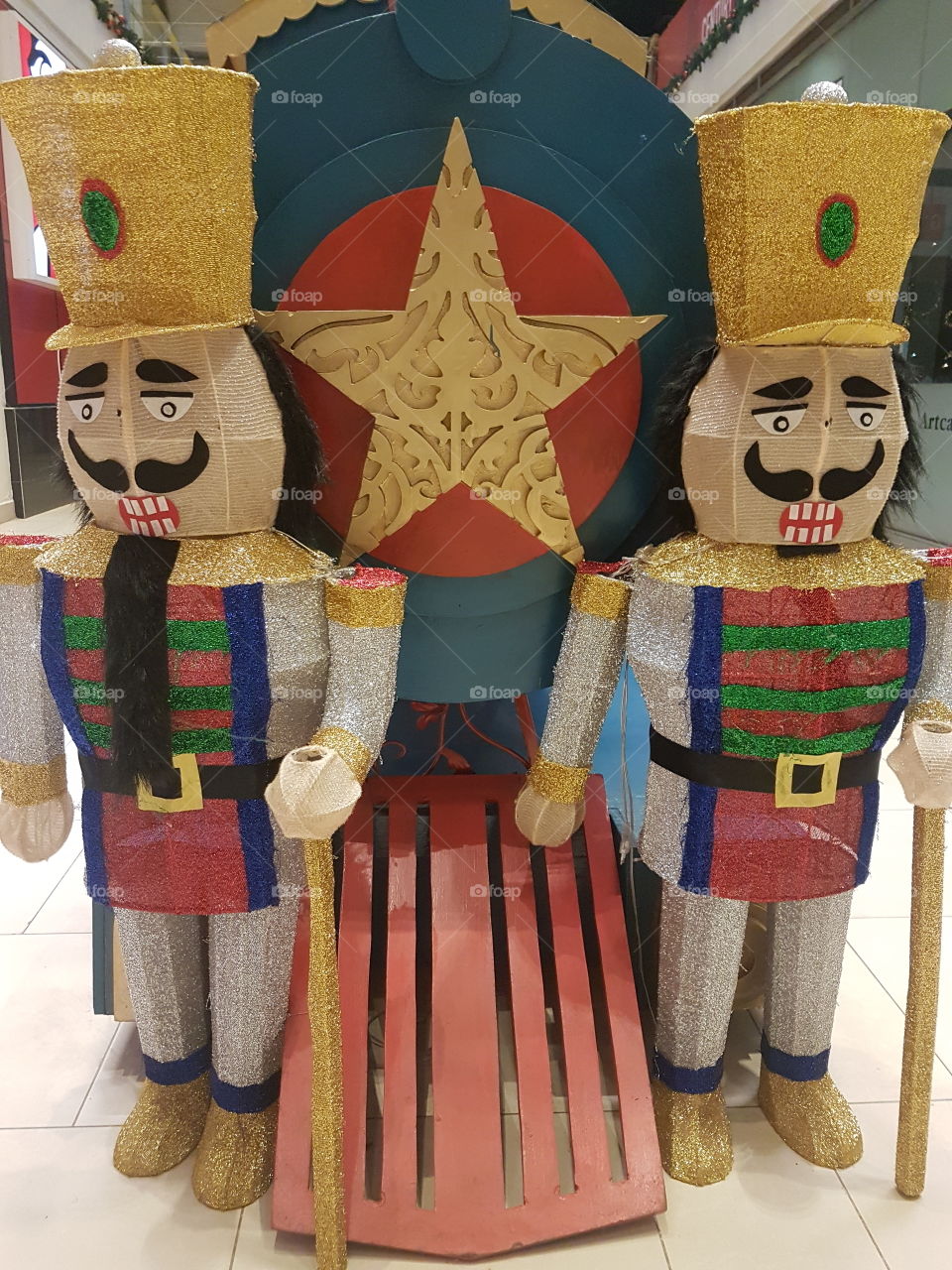 Christmas decorations involving two men who are in front of a train their faces show the emotions happening at the moment.