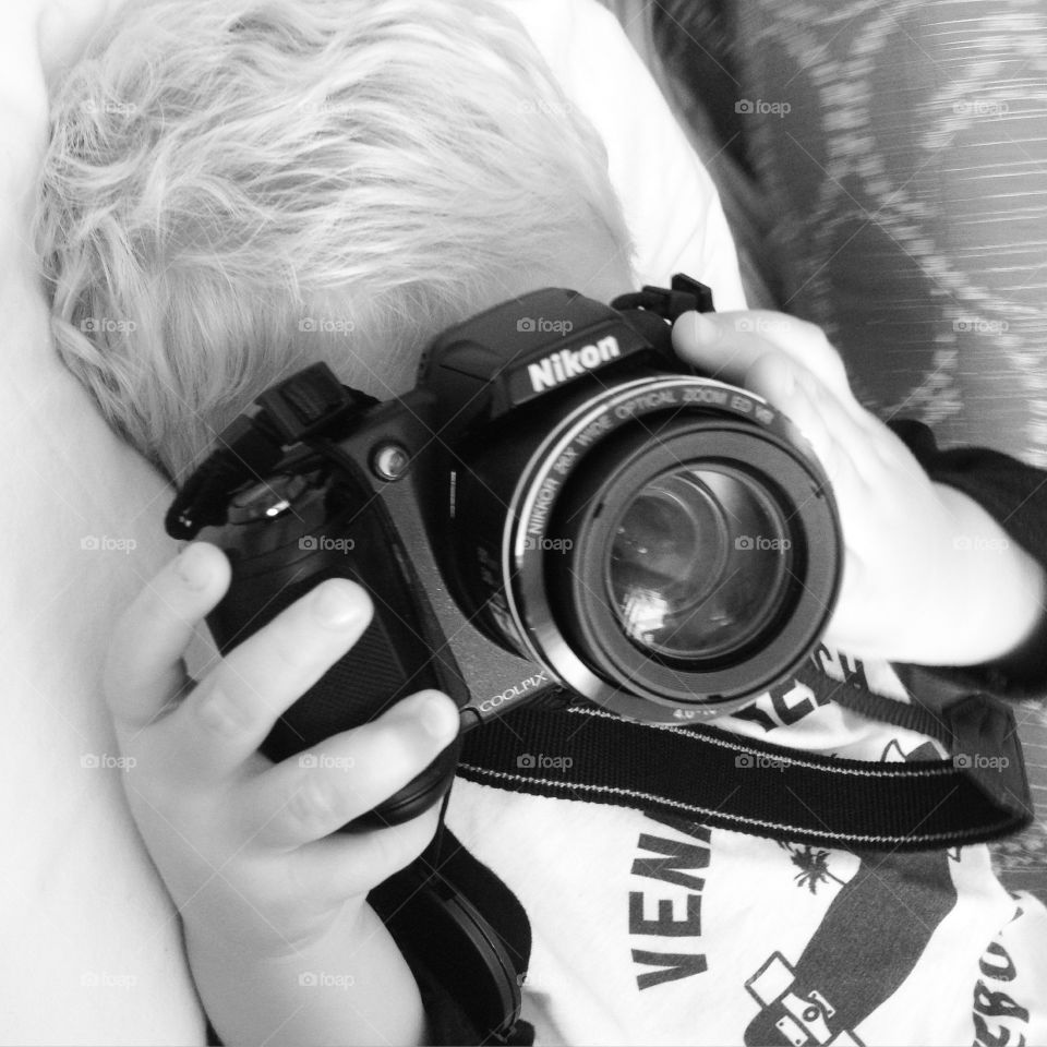 Designated photographer . Sitting in bed at the hotel Bodhi started to play with my camera 