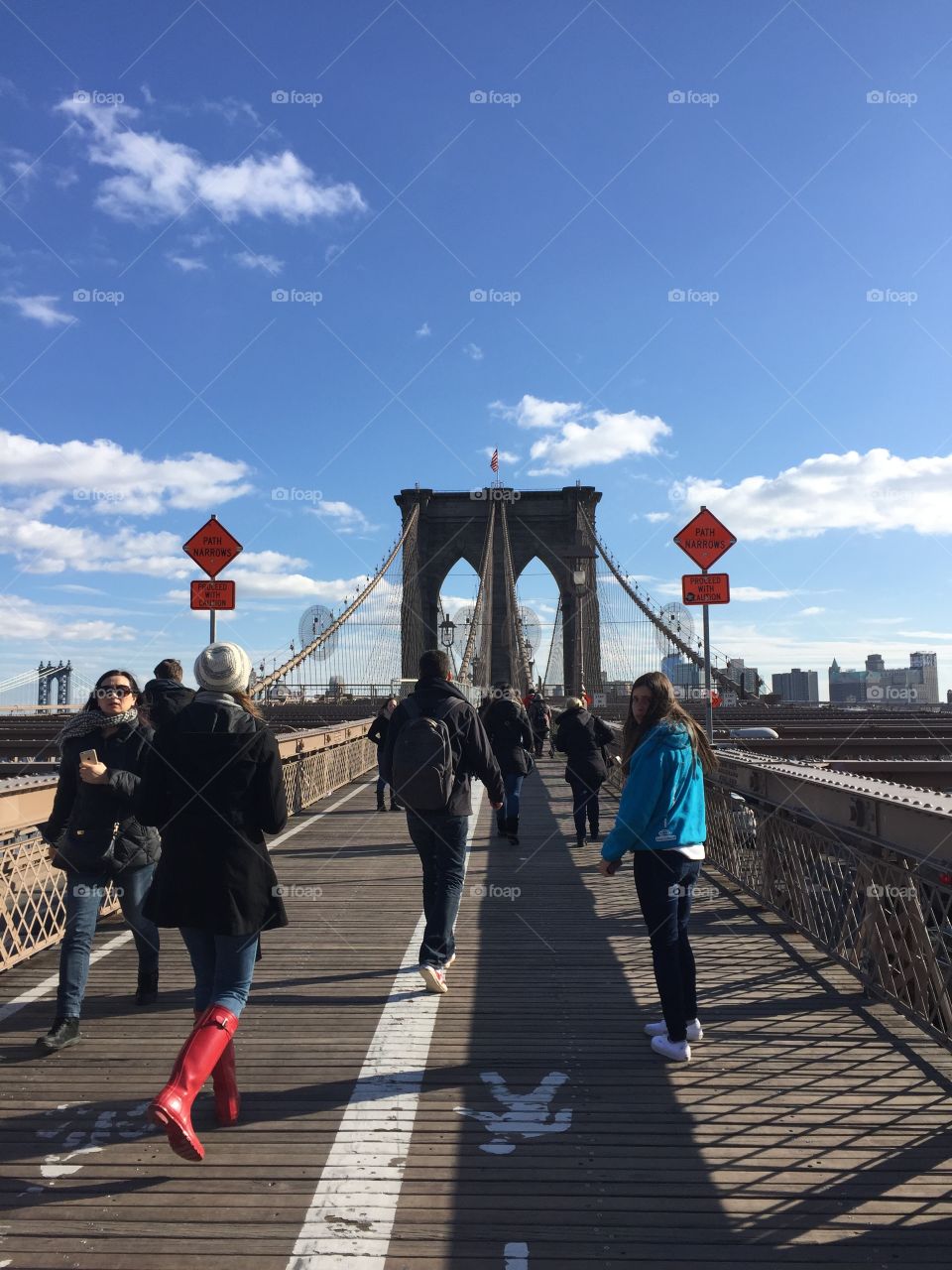 Group of people walking on bridge