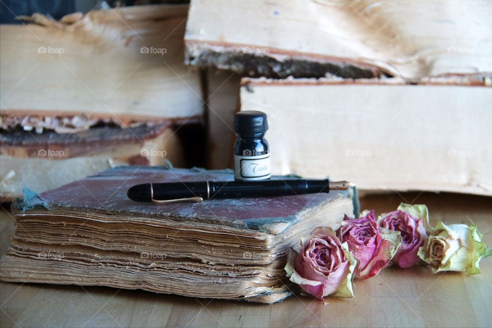 Old book and dried roses