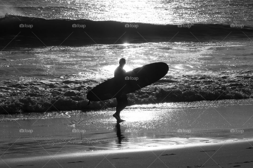 Lone surfer on the Atlantic Ocean coast in Portugal 