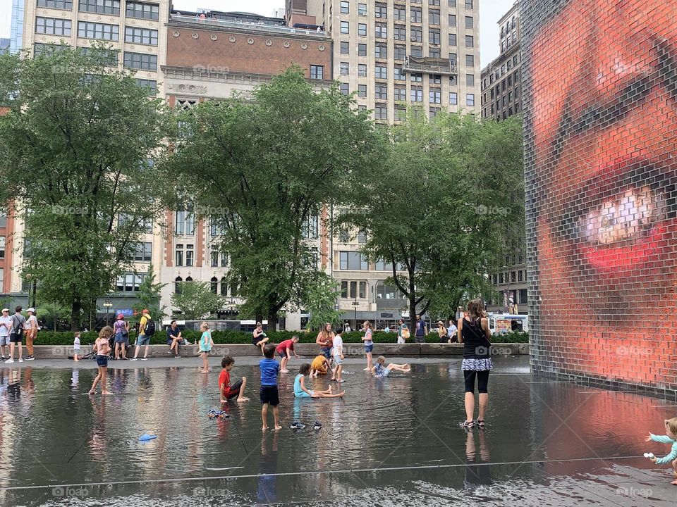 Children playing at the splash Park locate and in the heart of Chicago millennial park