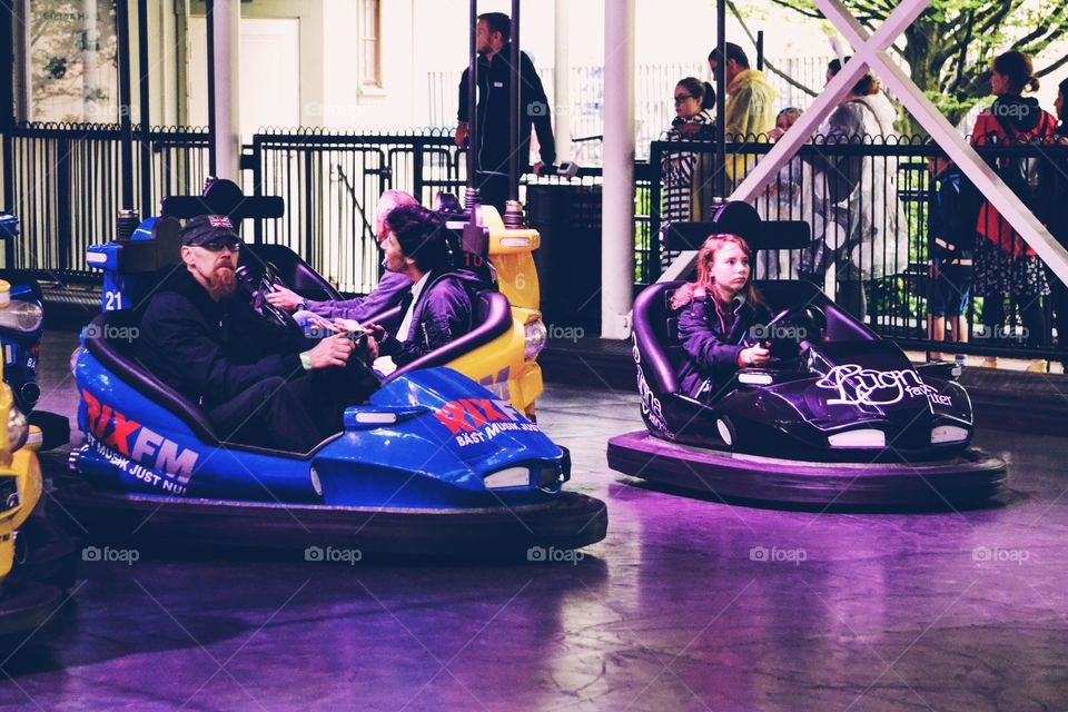 People driving bumper cars