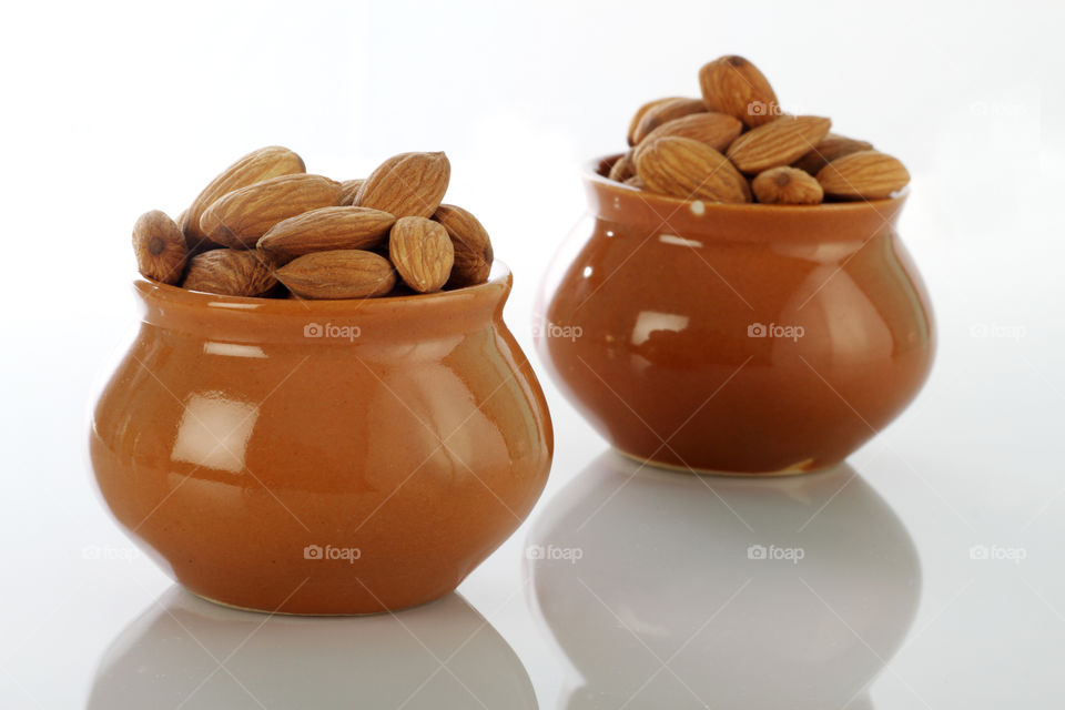 Dry fruit almonds in a ceramic pot