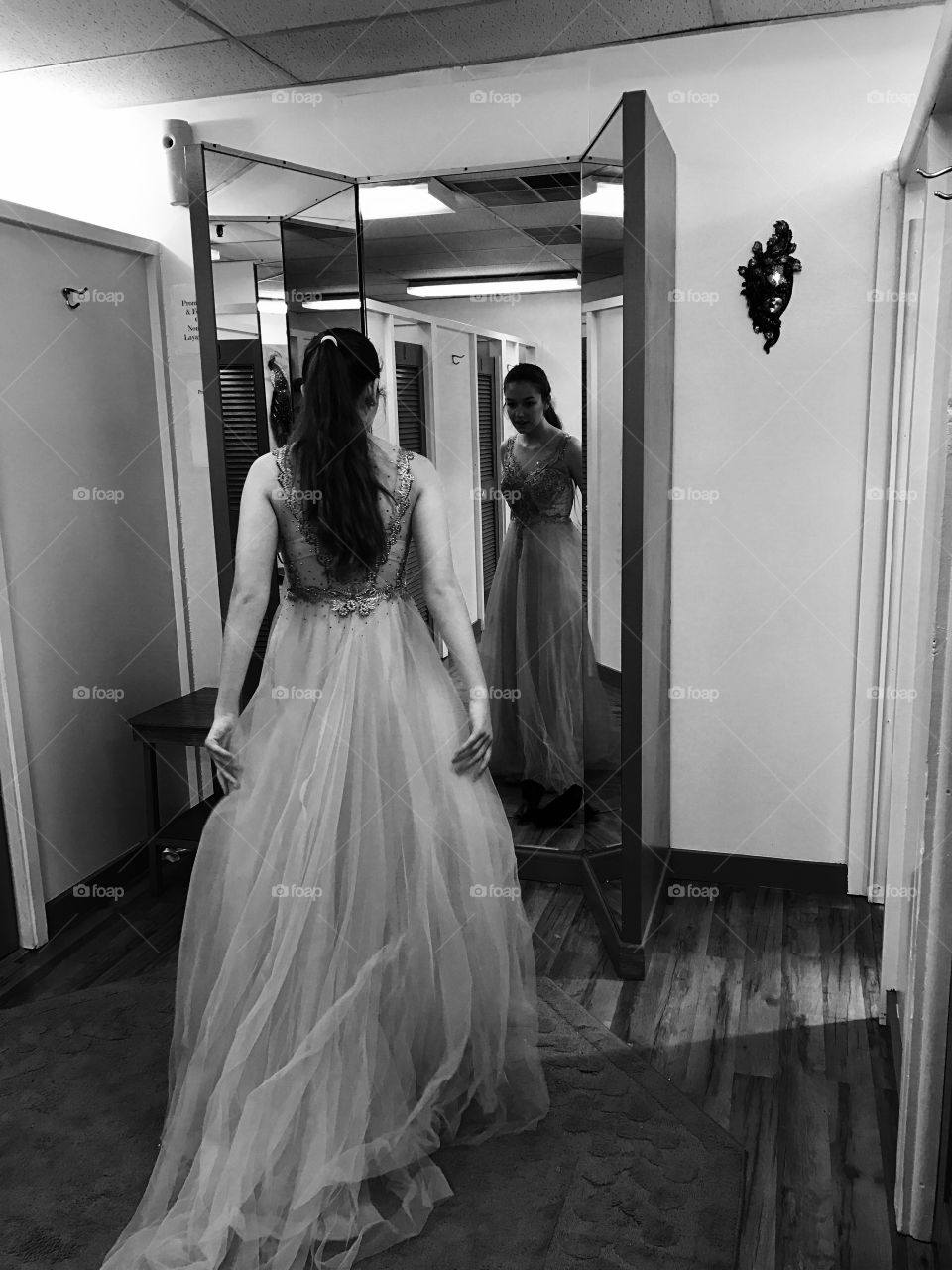 Beautiful bride standing in front of mirror