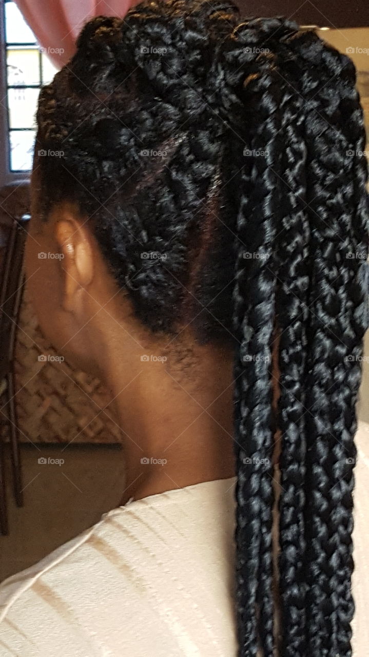 Hair styled in corn rows