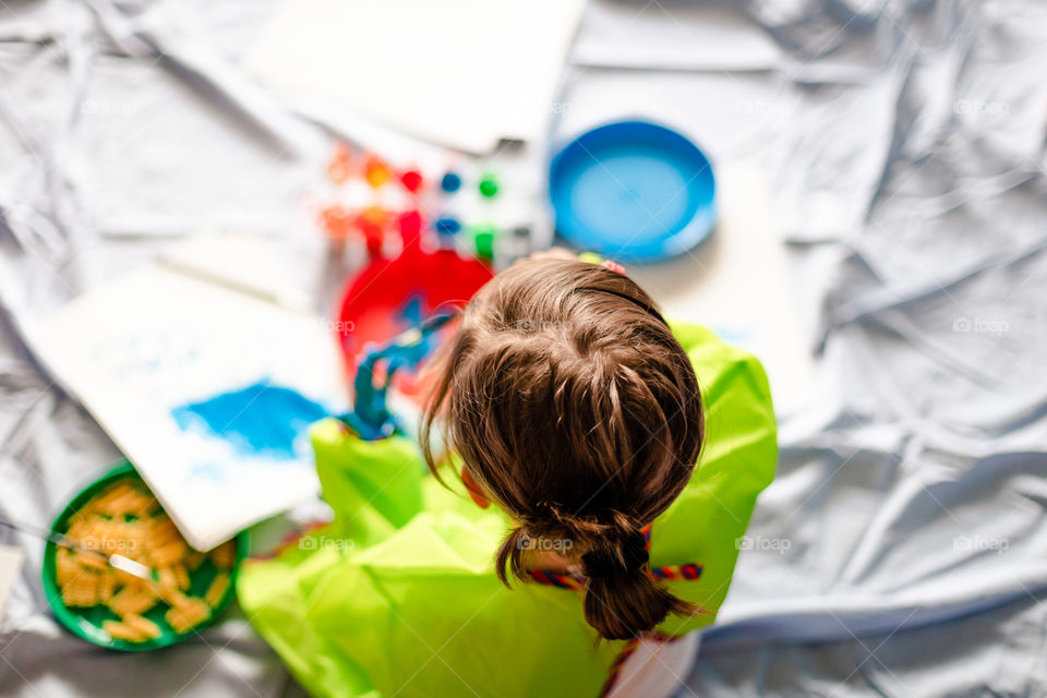 Child while painting at home during the quarantine