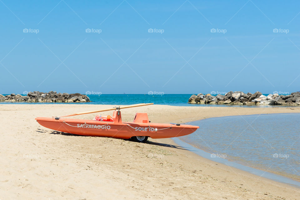orange lifeboat on the beach