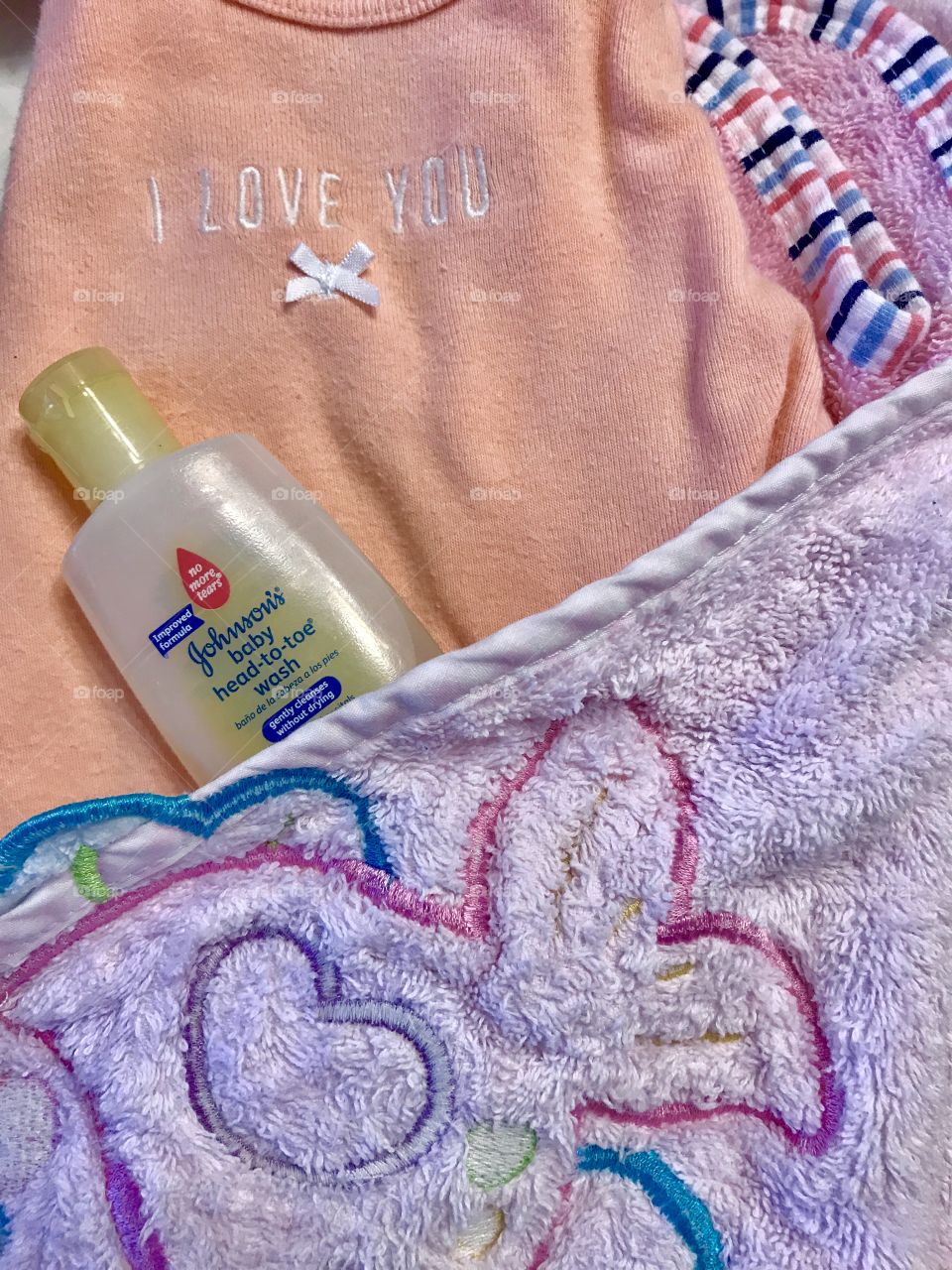 Baby Bath supplies with clothes, towel and Johnson’s head to toe baby wash. 