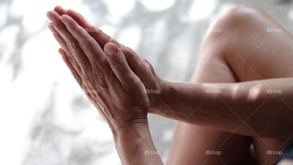 Closeup of Senior hands in prayer meditating