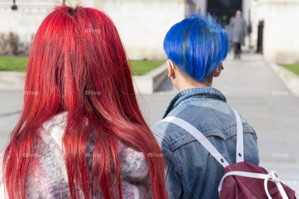 A couple with red and blue dyed hair