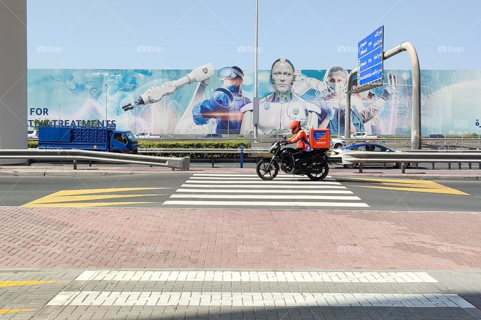 A Man Rides Motorcycle on City Road, Dubai