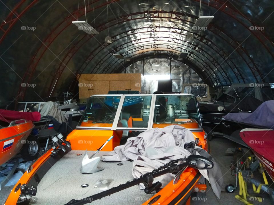 hangar with light river boats.