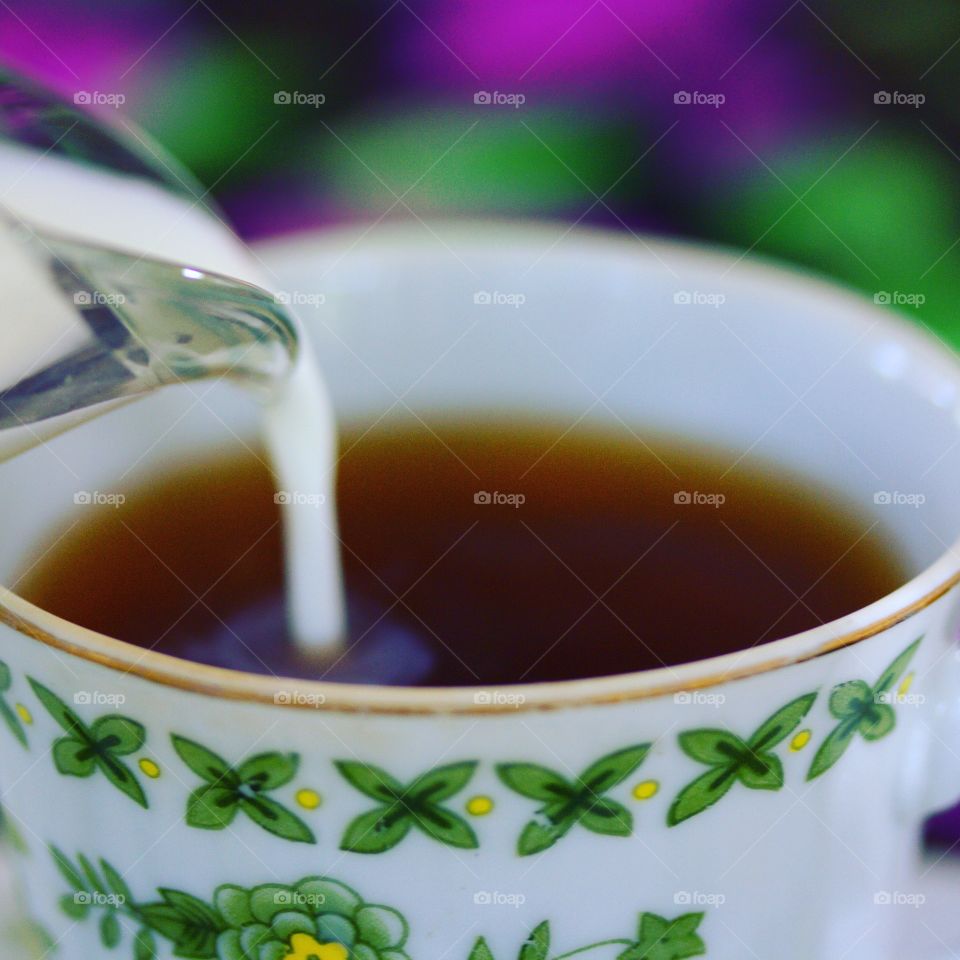 milk poured into tea for teatime